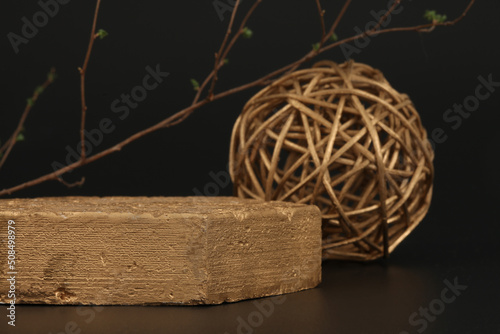 Empty texture gold stone platform eco podium and leaf twig on black copy space background. Minimal still life display product presentation scene. photo