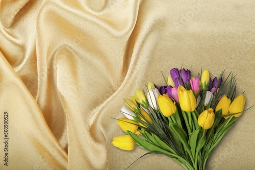 Female hands holding bunch of tulips on textile background. Easter, Mothers day, March 8 International Women's day. photo