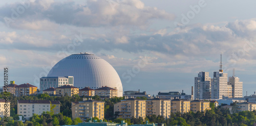 Evening sun over the arena Globen, Davicii, and apartment buildings in the district Hammarby a summer day in Stockholm photo