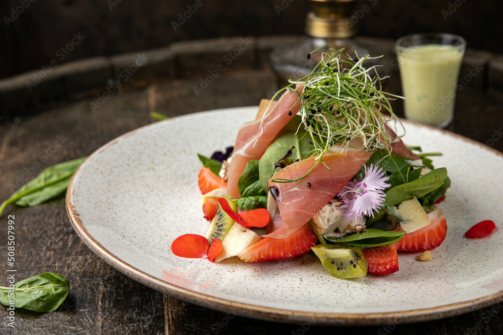 Salad with strawberries, parmesan and prosciutto. Salad with strawberries, parmesan and prosciutto.