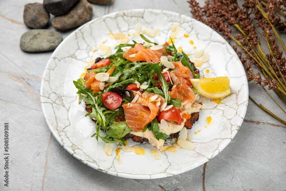 Salad with salmon, caviar, herbs, cherries Salad with salmon, caviar, herbs, cherries