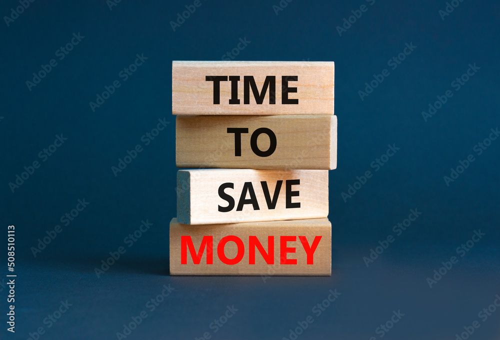 Time to save money symbol. Concept words Time to save money on wooden blocks on a beautiful grey table grey background. Business, finacial and time to save money concept. Time to save money symbol. Concept words Time to save money on wooden blocks on a beautiful grey table grey background. Business, finacial and time to save money concept.