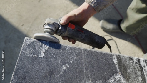 Work with a grinder on granite stone. Polishing of granite surface.