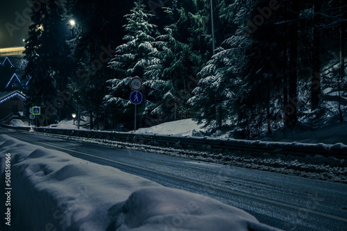 Night view of the road in winter. Snow-covered road with illumin photo