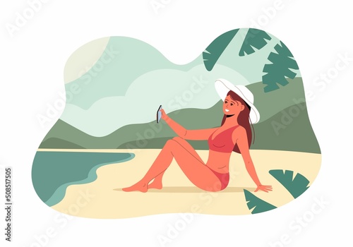 Woman in bikini taking a selfie on the sea beach. Pretty young woman in swimsuite, sitting on sand and shooting smartphone self portrait, posting vacation travel selfie photos to social media, blog