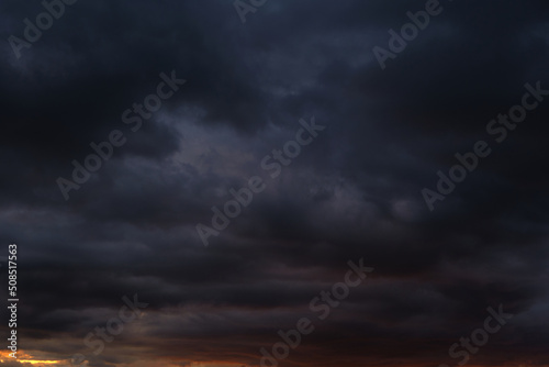 Thunderstorm dramatic clouds during evening sunset.