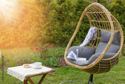 Принти на полотні Rattan garden swing with cushion in the garden, seating area in the yard