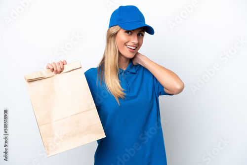 Young Uruguayan woman taking a bag of takeaway food isolated on white background laughing