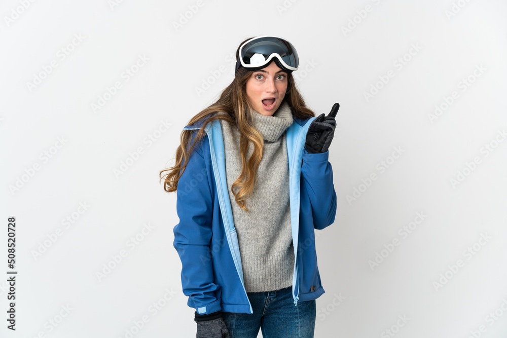Skier girl with snowboarding glasses isolated on white background intending to realizes the solution while lifting a finger up
