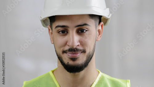Wallpaper Mural Front view male professional inspector arab man builder mechanic engineer worker wear special uniform hard hat smiling hispanic foreman posing for camera flash pleased with inspecting manufacture work Torontodigital.ca
