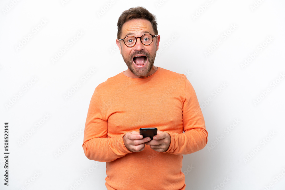 Middle age caucasian man isolated on white background surprised and sending a message Middle age caucasian man isolated on white background surprised and sending a message