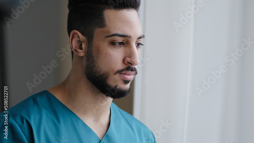 Konstfotografi Young pensive hispanic doctor male thoughtful arabian nurse practitioner therapi