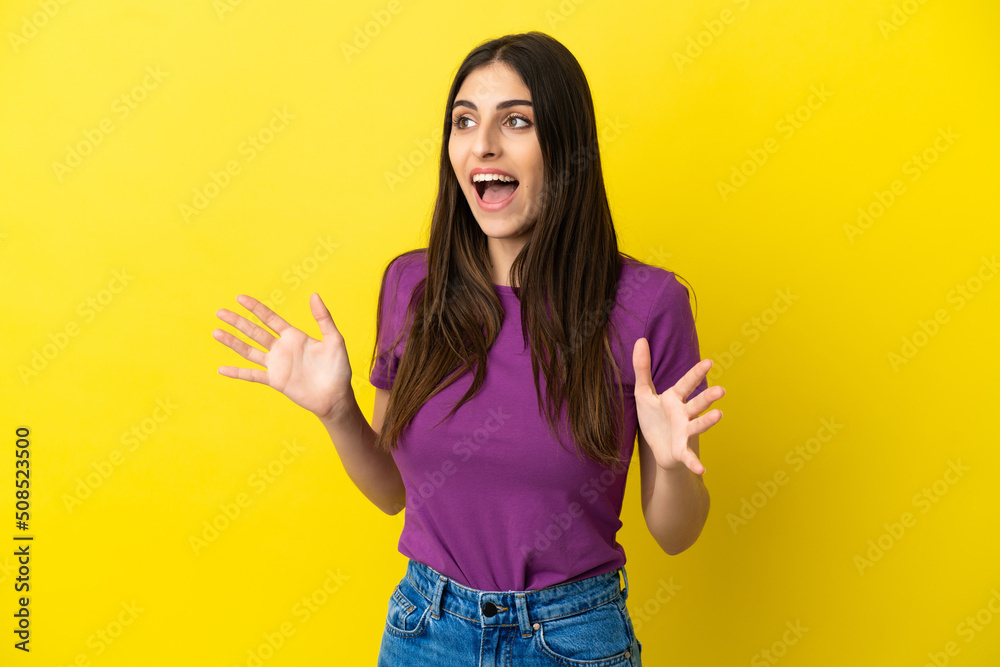 Young caucasian woman isolated on yellow background with surprise facial expression Young caucasian woman isolated on yellow background with surprise facial expression