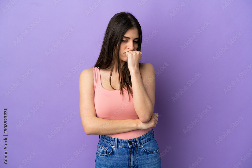 Young caucasian woman isolated on purple background having doubts Young caucasian woman isolated on purple background having doubts