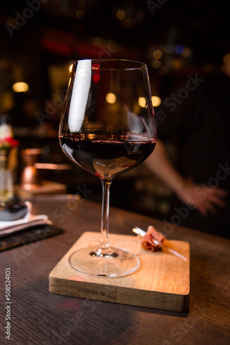 Red wine in a glass and a slice of jamon