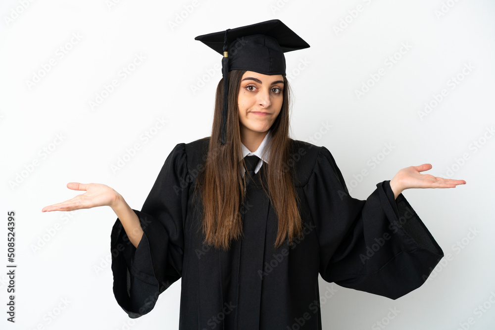 Young university graduate isolated on white background having doubts while raising hands Young university graduate isolated on white background having doubts while raising hands