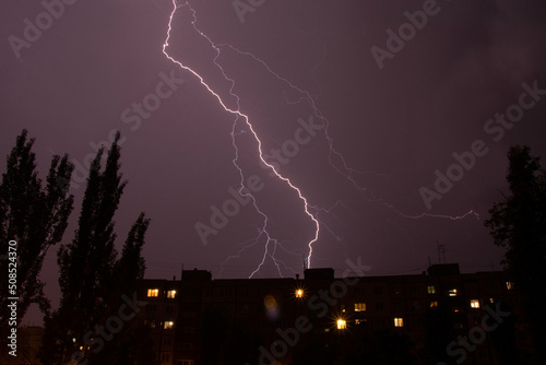 Lightning at night with heavy rain and thunder over Ukraine, lightning over the city in the night sky