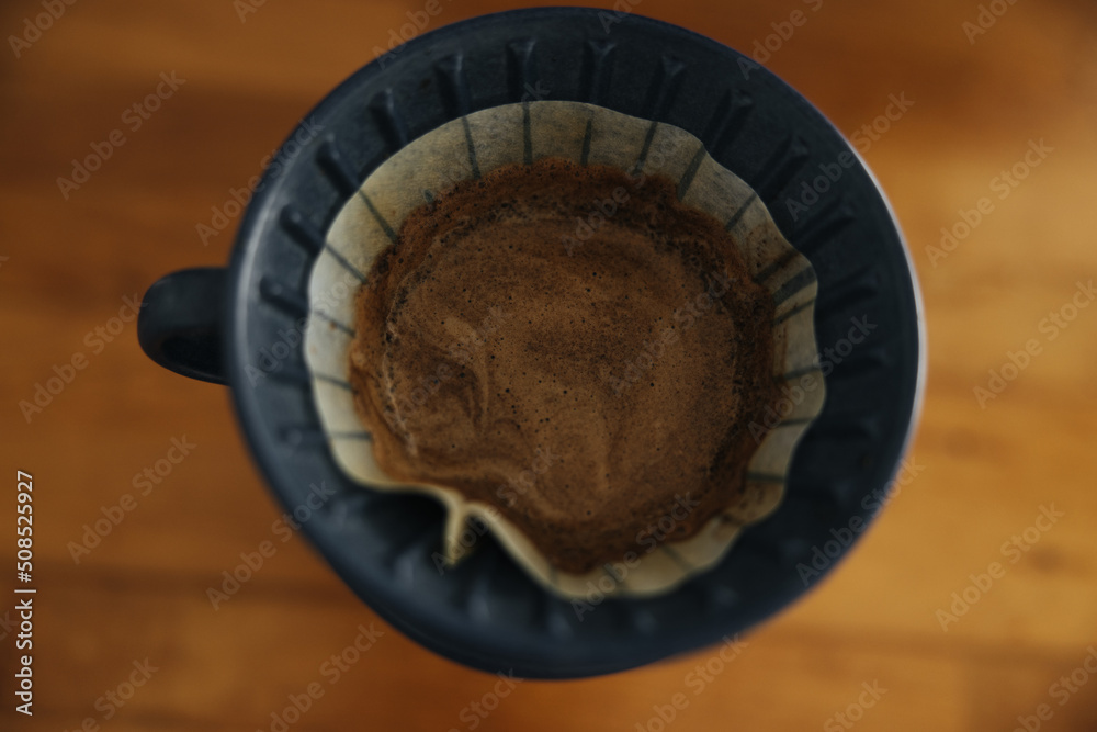 Close-up of black cup with brewed coffee on table. Close-up of black cup with brewed coffee on table.