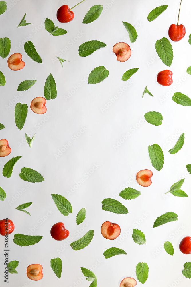 Summer background, frame with fresh cherry fruits and mint on white background. Flat lay. Summer fruits concept.
