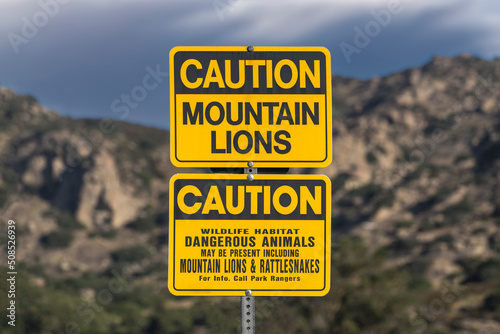 Caution Mountain Lions sign at Chatsworth Park South nature area in Southern California. 