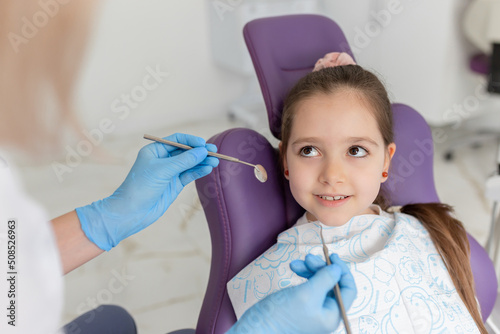 Little girl sitting in the dentists office