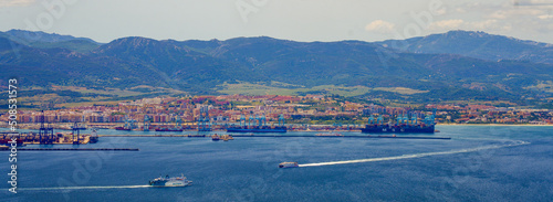 Panoramic view of the industrial port of Algésiras in the south of Spain - Giant cranes loading containers onto maritime freighters in the Mediterranean Sea