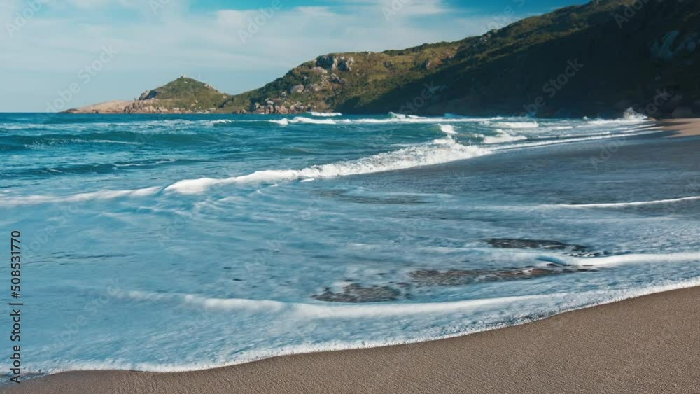 Beach in Brazil. Calm gentle waves roll on the sandy beach. Mole beach on the island of Santa Catarina in Brazil Beach in Brazil. Calm gentle waves roll on the sandy beach. Mole beach on the island of Santa Catarina in Brazil