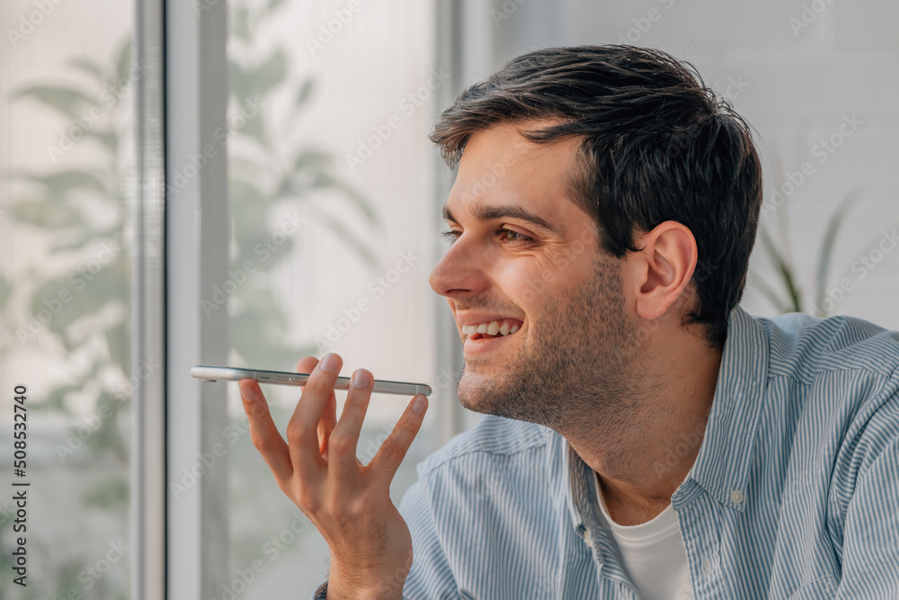 young man with mobile phone sending or recording voice message young man with mobile phone sending or recording voice message