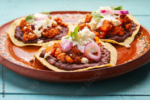 picadillo corn tostadas with cheese and beans. Mexican food photo