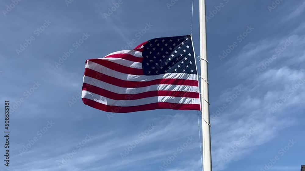 US flag (Stars and Stripes) at half mast waving in the wind - k4 video US flag (Stars and Stripes) at half mast waving in the wind - k4 video
