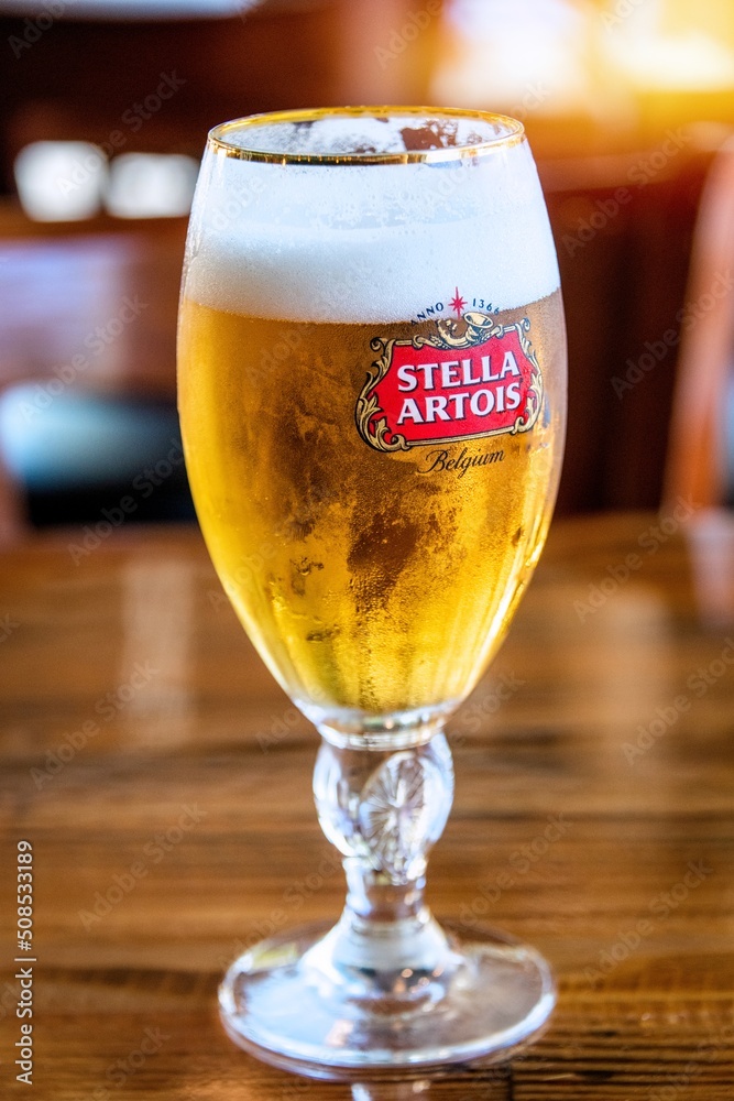 San Jose, CA/USA 05/20/2022 Glass containing cold Stella Artois brand  pilsen style draft beer over a bar counter Photos | Adobe Stock