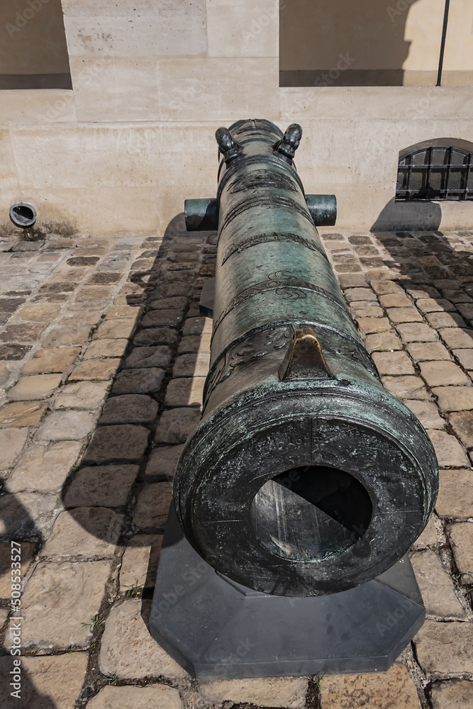 Historic Napoleonic artillery gun near Les Invalides in Paris. Les Invalides (National Residence of Invalids) - complex of museums and monuments relating to military history of France.