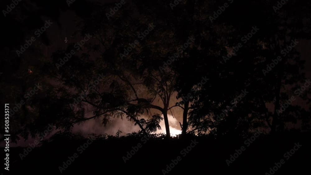 Exploded transformer catches fire and creates massive smoke cloud with bright flashing lights on a cold wet New Jersey night