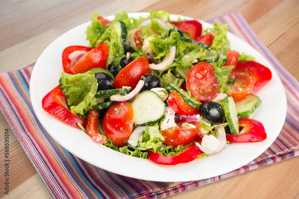 Fresh spring vegetable salad with tomatoes and peppers in the bowl. Fresh spring vegetable salad with tomatoes and peppers in the bowl.