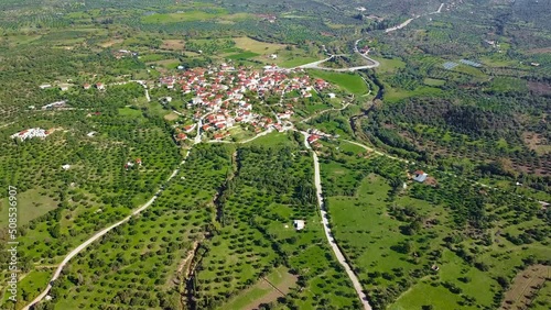 Aerial view of small village and crop fields at Autumn