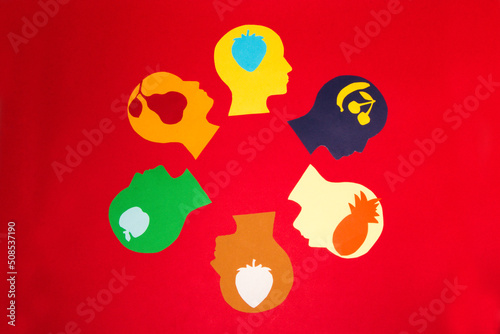 colorful paper head arranged in a circle on a red background, each head has a different crust of fruit, creative summer fresh design, colorful minimalism, what kind of vitamins do you choose today?