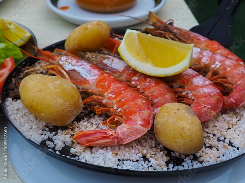 Canarian plate with potato, fish with red scales and big shrimps. Typical canarian food in Restaurant  photo