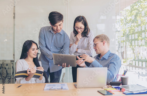 Business team working on a new business plan with modern digital computer