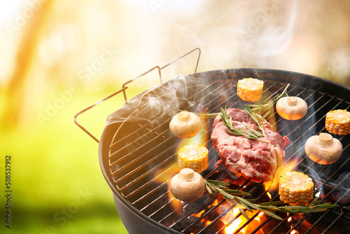 Barbecue grill with raw mea...