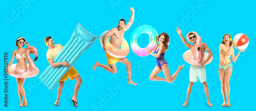 Set of happy young people with inflatable rings and mattress on light blue background