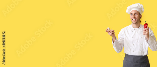 Handsome male chef on yello...