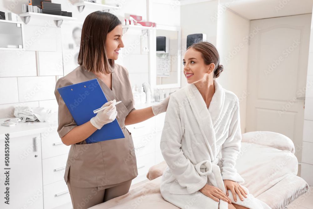 Pretty young woman visiting cosmetologist in beauty salon Pretty young woman visiting cosmetologist in beauty salon