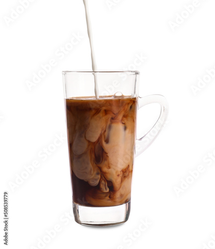 Pouring of milk into glass cup with iced coffee on white background