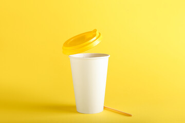 Takeaway paper cup on yellow background