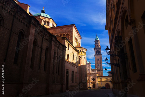 View of narrow street of Italian city of Parma with belfry of San Giovanni Evangelista church photo