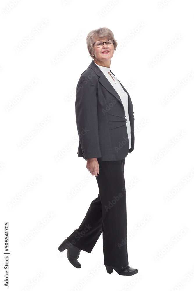 Side view of happy senior businesswoman wearing glasses and walking Side view of happy senior businesswoman wearing glasses and walking