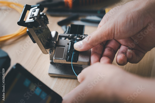  template Technician Fiberoptic Fusion Splicing. Worker connecting for Cable Internet signal and Wire connection with Fiber Optic Fusion Splicing machine,fiber optic cable splice machine in work
