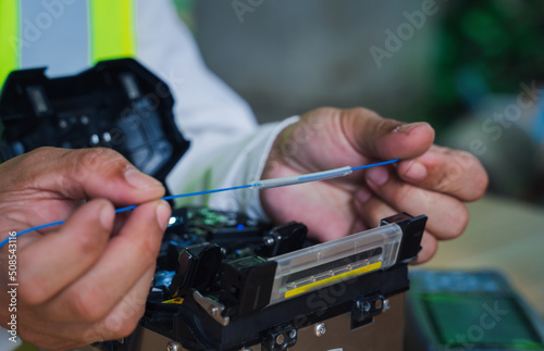  template Technician Fiberoptic Fusion Splicing. Worker connecting for Cable Internet signal and Wire connection with Fiber Optic Fusion Splicing machine,fiber optic cable splice machine in work photo