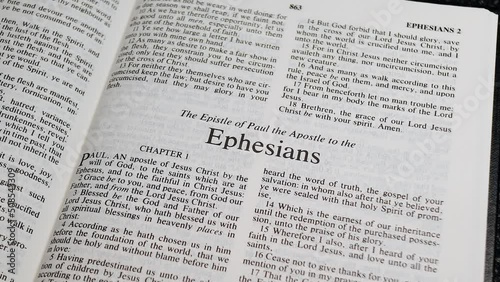 Close Up Shot of  Bible Page Turning to the book of Ephesians photo
