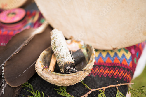 A bundle of sage and an eagle feather are laid out in preparation of a Native American, Indian, or Indigenous smudging ceremony.  Pemberton BC, Canada. ..